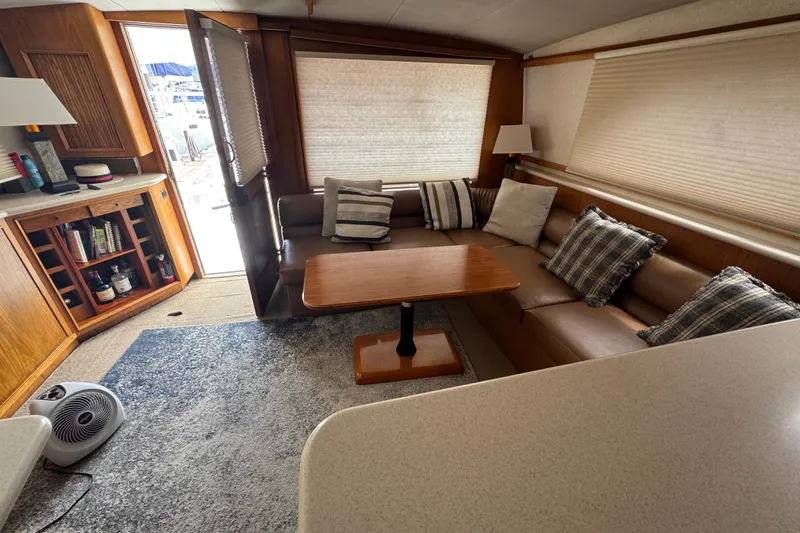 Slide: The Image of Interior of 1988 Bertram 50 Convertible yacht with cozy seating and wooden cabinetry. - 39