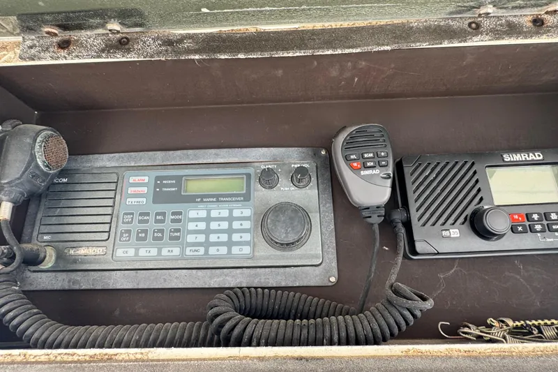 Slide: The Image of Marine radio equipment on a 1988 Bertram 50 Convertible boat dashboard. - 41
