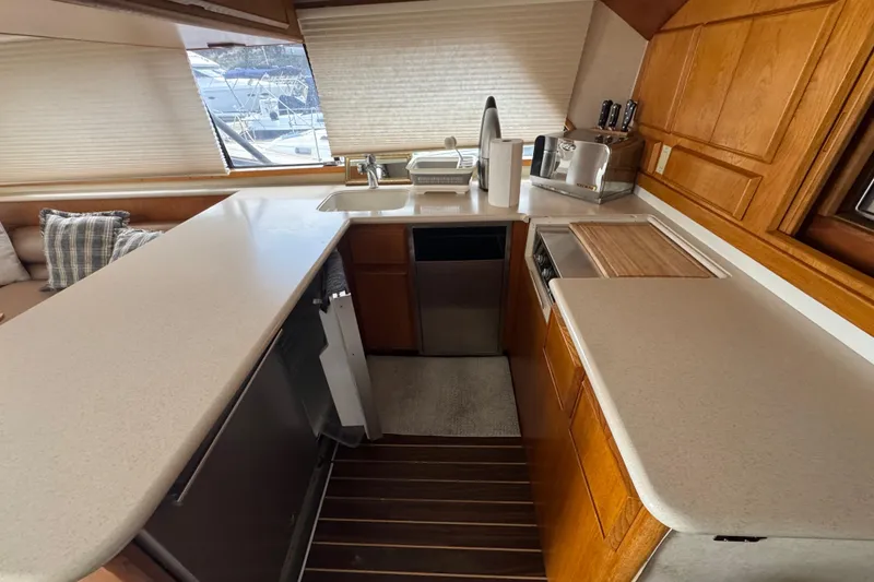 Slide: The Image of 1988 Bertram 50 Convertible yacht kitchen with modern appliances and wooden cabinetry. - 43