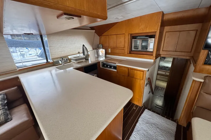 Slide: The Image of Interior of a 1988 Bertram 50 Convertible yacht with modern kitchen amenities. - 44