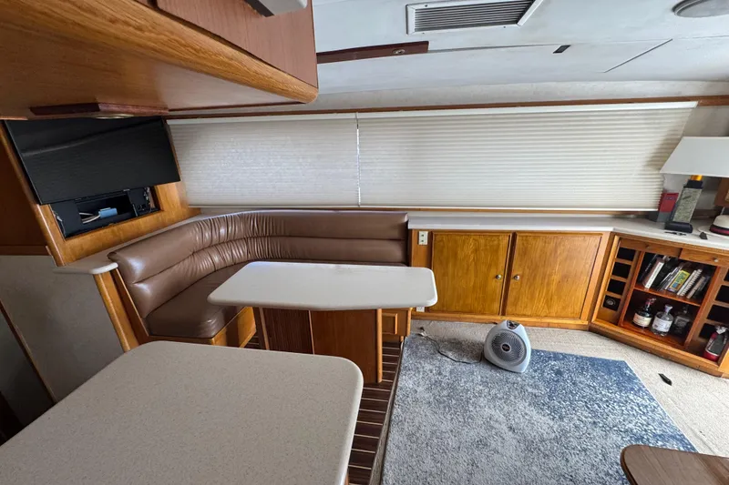 Slide: The Image of Interior of a 1988 Bertram 50 Convertible yacht with cozy seating and wooden cabinetry. - 45