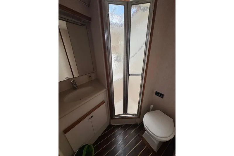 Slide: The Image of Bathroom interior of 1988 Bertram 50 Convertible yacht with shower, sink, and toilet. - 47
