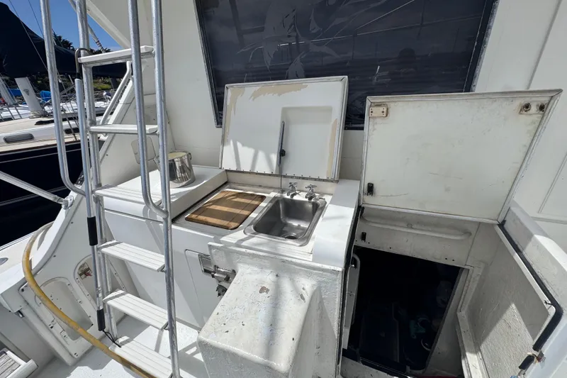 Slide: The Image of Outdoor kitchen area on a 1988 Bertram 50 Convertible yacht with sink and storage. - 5