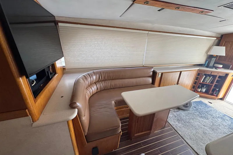 Slide: The Image of Interior of 1988 Bertram 50 Convertible yacht with leather seating and wooden cabinetry. - 50