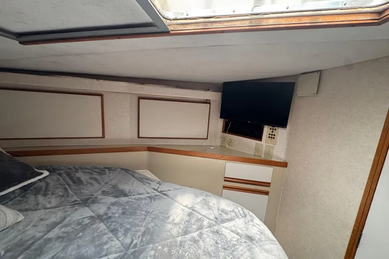 Slide: The Image of Cozy cabin interior of 1988 Bertram 50 Convertible with bed and mounted TV. - 56