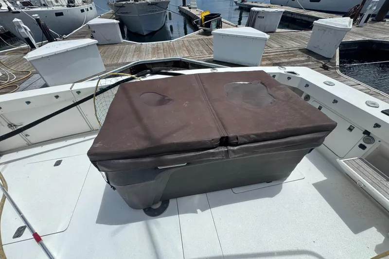 Slide: The Image of 1988 Bertram 50 Convertible boat deck with covered storage box at marina. - 6