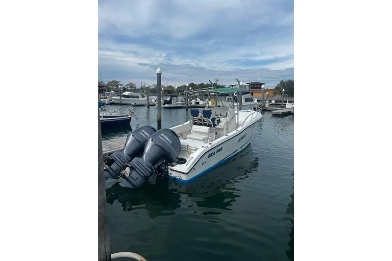 The Image of 2001 Sea Pro 255 Center Console boat docked with twin outboard engines. - 1