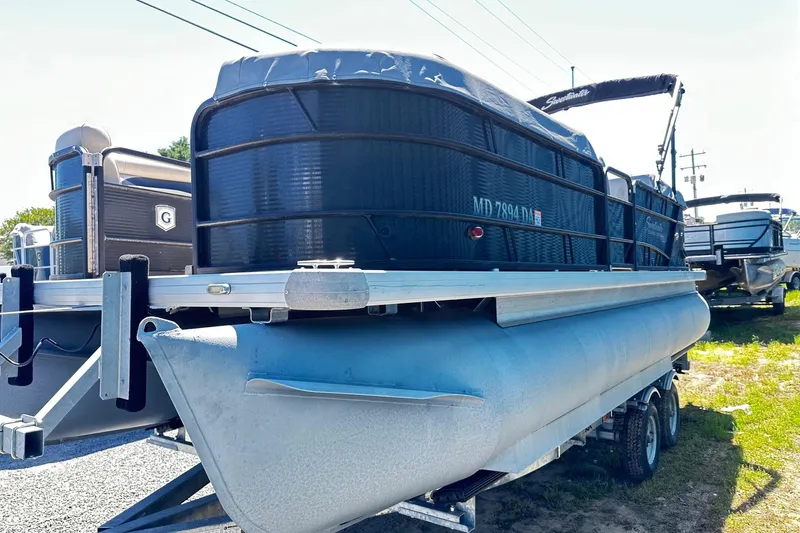 Slide: The Image of 2016 Godfrey Sweetwater 2286SB pontoon boat on trailer, parked outdoors. - 1