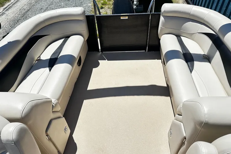 Slide: The Image of Interior view of a 2016 Godfrey Sweetwater 2286SB pontoon boat with beige seating. - 10