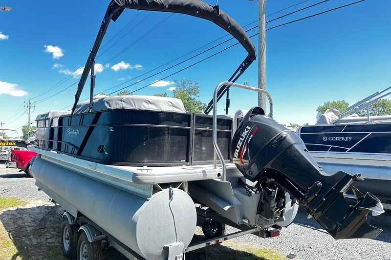 Slide: The Image of 2016 Godfrey Sweetwater 2286SB pontoon boat with Suzuki outboard motor on trailer. - 3