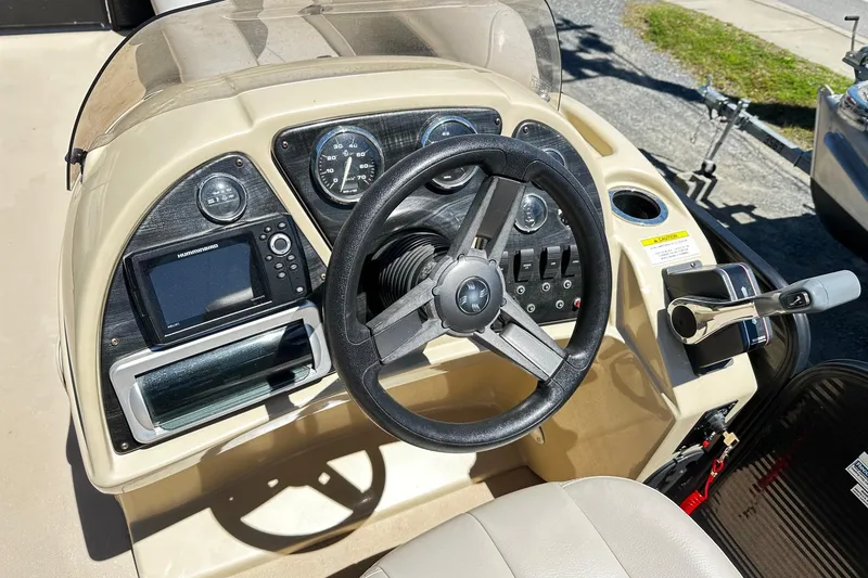 Slide: The Image of 2016 Godfrey Sweetwater 2286SB boat dashboard with steering wheel and control panel. - 4
