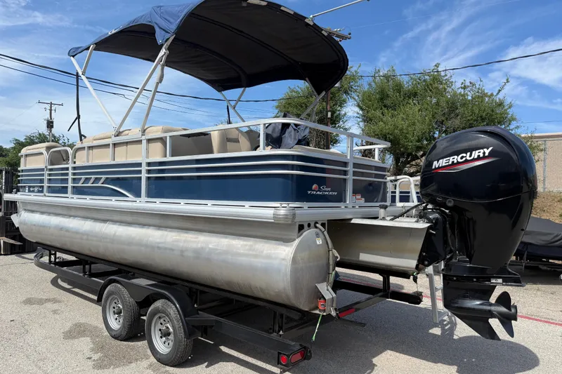 Slide: The Image of 2021 Sun Tracker SportFish 22 DLX pontoon boat with Mercury outboard motor on trailer. - 12