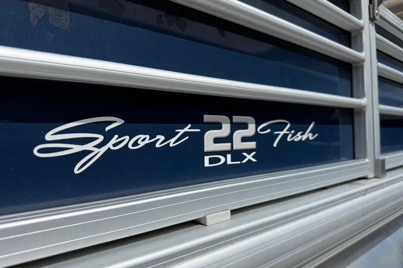 Slide: The Image of 2021 Sun Tracker SportFish 22 DLX logo on blue background with silver accents. - 17