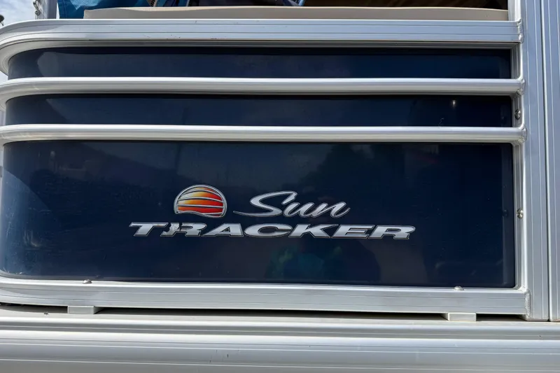 Slide: The Image of 2021 Sun Tracker SportFish 22 DLX boat logo on dark blue panel. - 21