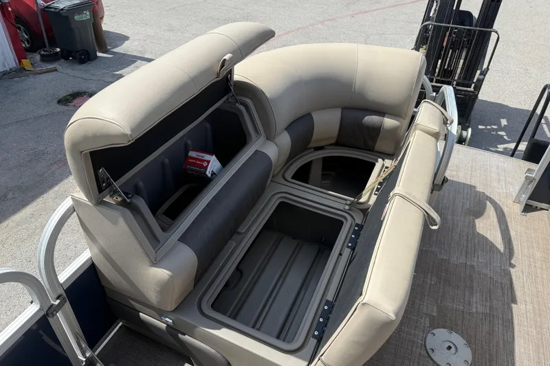Slide: The Image of 2021 Sun Tracker SportFish 22 DLX pontoon boat with open storage compartments and beige seating. - 25