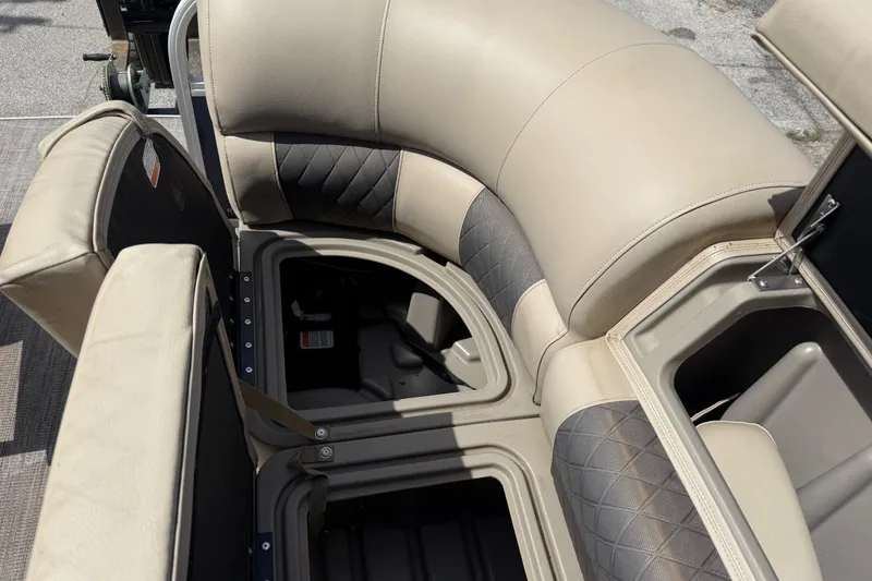 Slide: The Image of 2021 Sun Tracker SportFish 22 DLX boat seating with storage compartments open. - 29