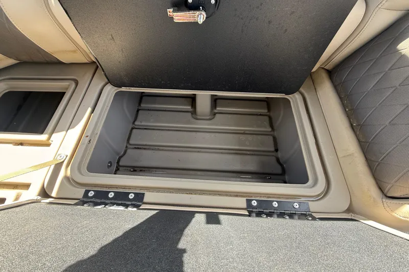 Slide: The Image of Open storage compartment on 2021 Sun Tracker SportFish 22 DLX boat, featuring beige interior. - 31