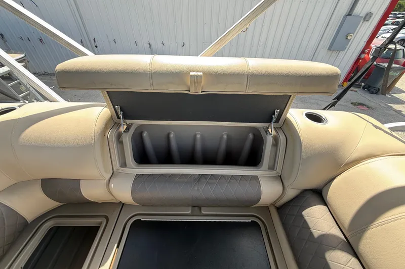 Slide: The Image of 2021 Sun Tracker SportFish 22 DLX boat seat storage compartment open, showcasing interior design. - 33