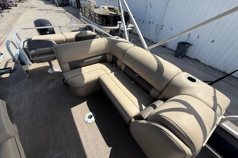 Slide: The Image of 2021 Sun Tracker SportFish 22 DLX pontoon boat with beige seating and spacious deck. - 35