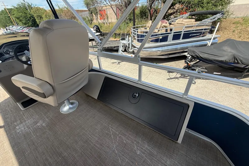 Slide: The Image of 2021 Sun Tracker SportFish 22 DLX interior with captain's chair and outdoor view. - 40