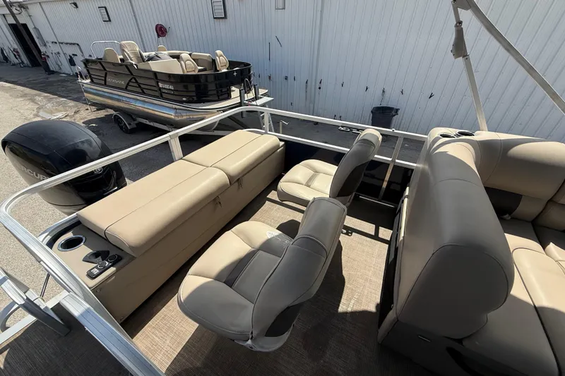 Slide: The Image of 2021 Sun Tracker SportFish 22 DLX pontoon boat with beige seating and Mercury outboard motor. - 42
