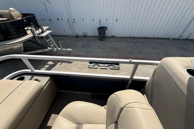 Slide: The Image of 2021 Sun Tracker SportFish 22 DLX interior with beige seating and cup holders. - 47