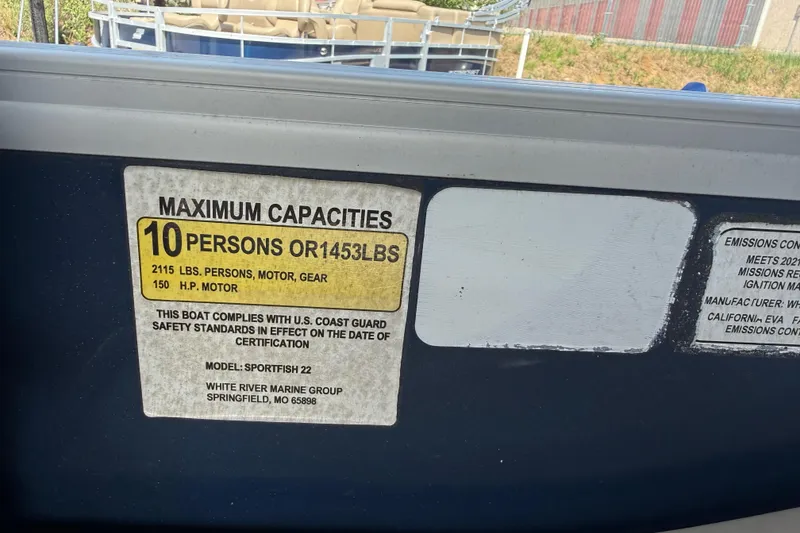 Slide: The Image of 2021 Sun Tracker SportFish 22 DLX capacity label, 10 persons or 1453 lbs, 150 HP motor. - 49