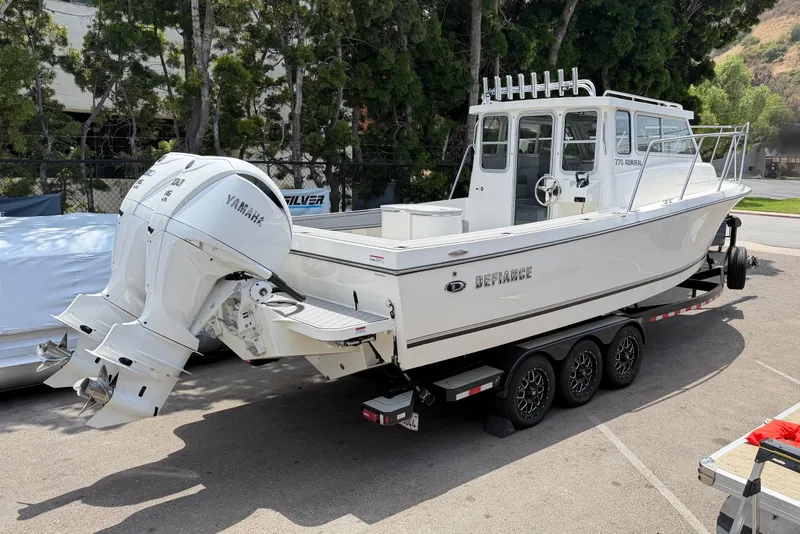 Slide: The Image of 2026 Defiance Admiral 270 EX boat on trailer with dual Yamaha outboard engines. - 10