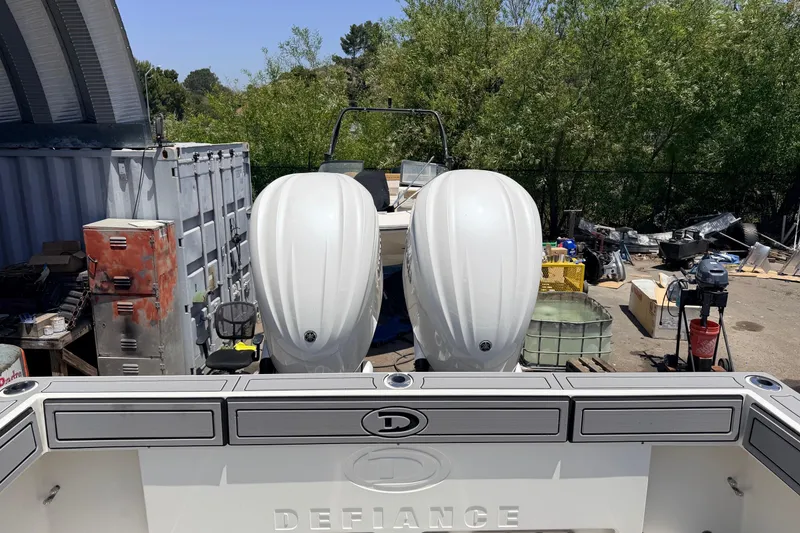 Slide: The Image of 2026 Defiance Admiral 270 EX boat with dual engines in a yard setting. - 12