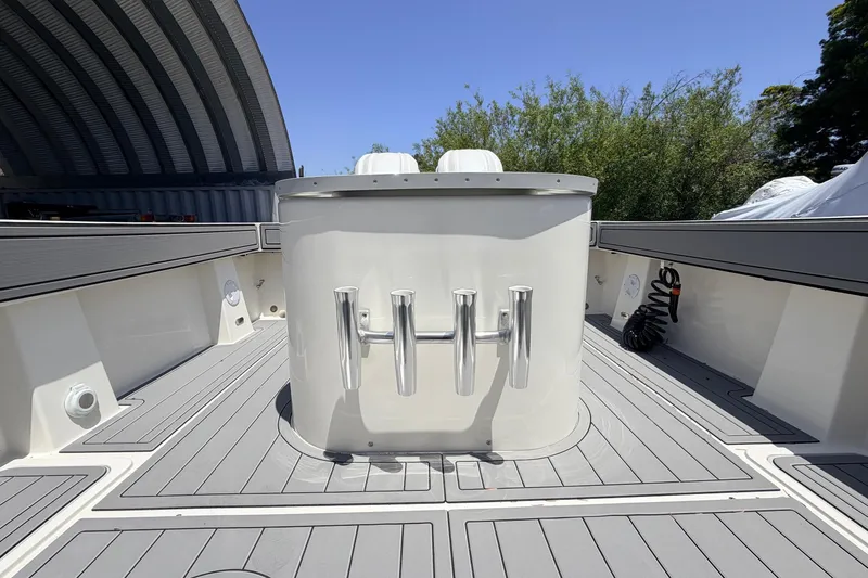 Slide: The Image of 2026 Defiance Admiral 270 EX boat deck with rod holders, under a clear blue sky. - 17