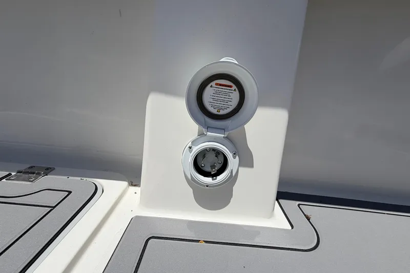 Slide: The Image of Power outlet on 2026 Defiance Admiral 270 EX boat deck, with safety instructions visible. - 23