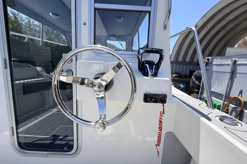 Slide: The Image of Steering wheel and controls of 2026 Defiance Admiral 270 EX boat. - 25