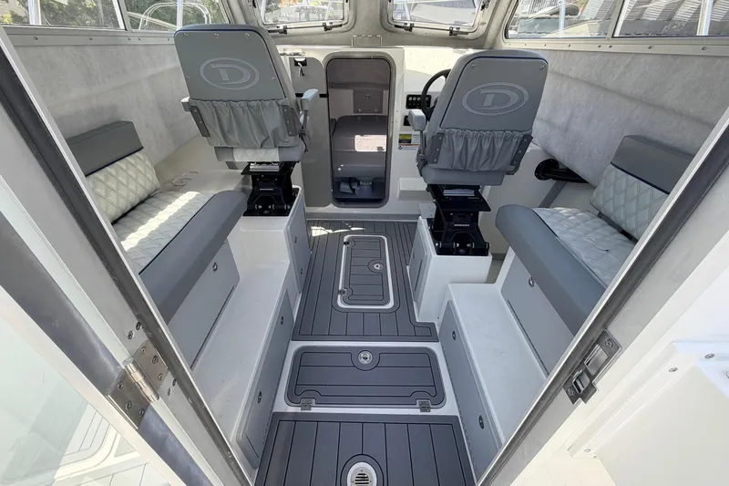 Slide: The Image of Interior of 2026 Defiance Admiral 270 EX boat, featuring modern seating and sleek design. - 27