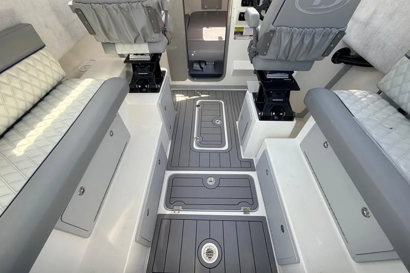 Slide: The Image of Interior of 2026 Defiance Admiral 270 EX boat with cushioned seating and storage compartments. - 28
