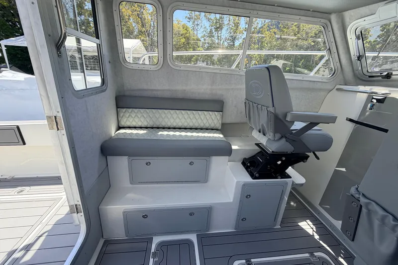 Slide: The Image of Interior of 2026 Defiance Admiral 270 EX boat with seating and helm chair. - 29