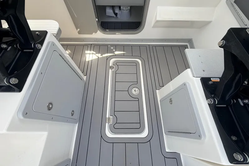Slide: The Image of 2026 Defiance Admiral 270 EX boat deck with sleek gray flooring and storage compartments. - 34