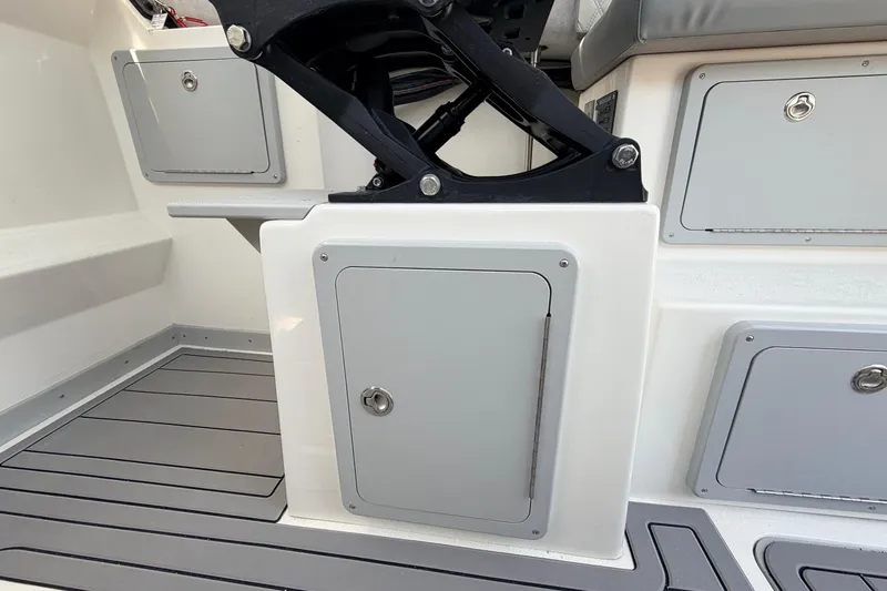 Slide: The Image of Interior of 2026 Defiance Admiral 270 EX boat, featuring storage compartments and seating. - 36