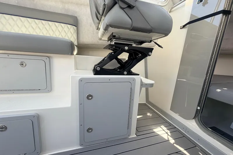 Slide: The Image of Interior of 2026 Defiance Admiral 270 EX boat, featuring seating and storage compartments. - 38