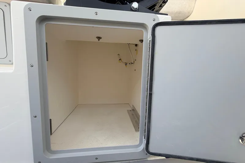 Slide: The Image of Open storage compartment on 2026 Defiance Admiral 270 EX boat. - 39