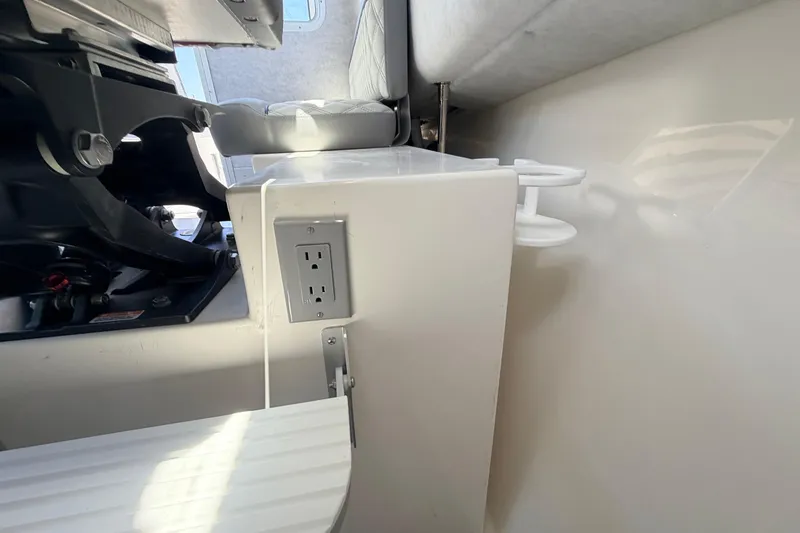 Slide: The Image of Interior of 2026 Defiance Admiral 270 EX boat, featuring seating and electrical outlet. - 41