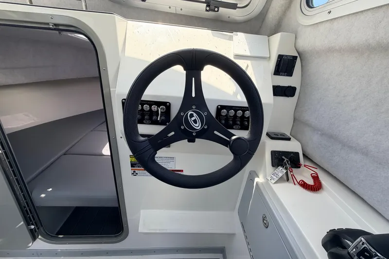 Slide: The Image of Interior view of 2026 Defiance Admiral 270 EX boat cockpit with steering wheel and controls. - 44