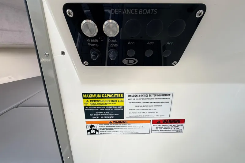 Slide: The Image of Control panel and safety labels on 2026 Defiance Admiral 270 EX boat. - 46