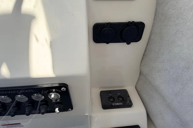 Slide: The Image of Control panel of 2026 Defiance Admiral 270 EX boat with Yamaha start-stop buttons. - 49