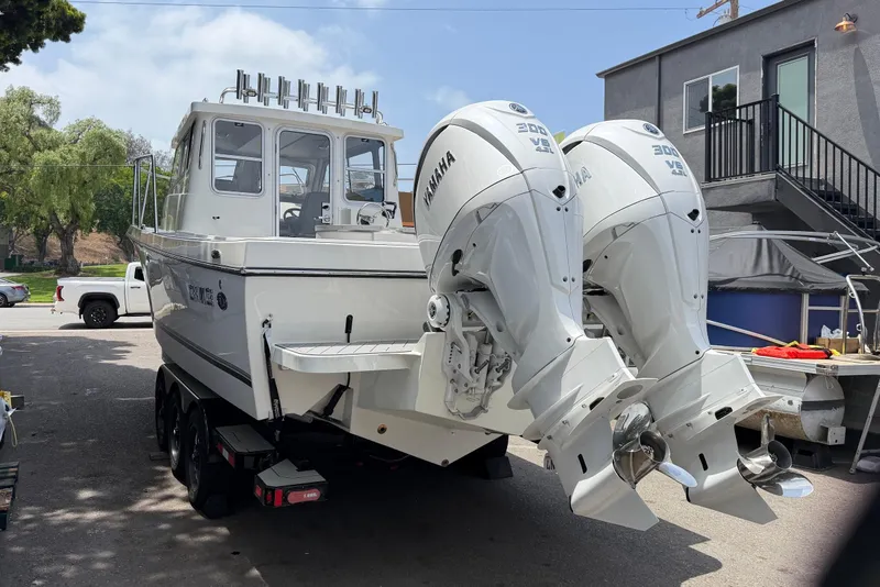 Slide: The Image of 2026 Defiance Admiral 270 EX boat with dual Yamaha 300 engines on a trailer. - 7