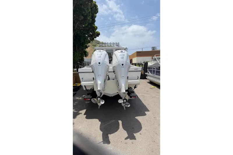 Slide: The Image of Twin outboard motors on a 2026 Defiance Admiral 270 EX boat, parked outdoors. - 8