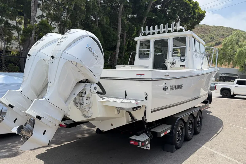 Slide: The Image of 2026 Defiance Admiral 270 EX boat with dual Yamaha engines on a trailer. - 9