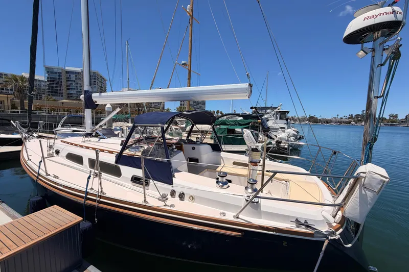 Slide: The Image of 2002 Sabre 362 sailboat docked in a marina under clear blue skies. - 12