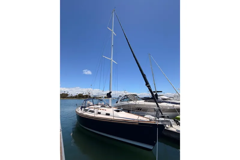 Slide: The Image of 2002 Sabre 362 sailboat docked under clear blue sky. - 2