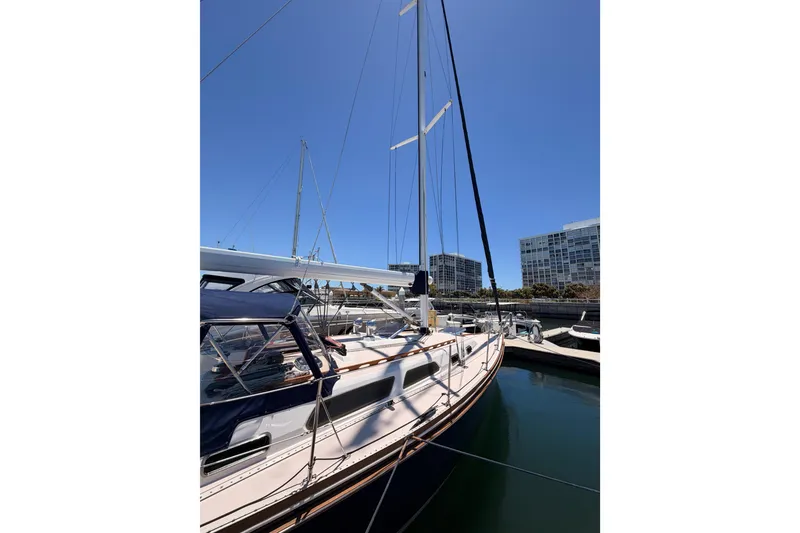 Slide: The Image of Sailboat Sabre 362, 2002 model, docked in a marina under clear blue sky. - 5