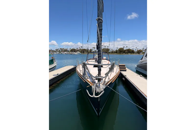 Slide: The Image of 2002 Sabre 362 sailboat docked in a marina under a clear blue sky. - 6